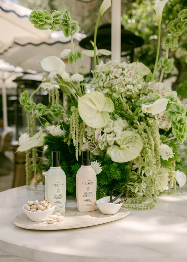 L’Occitane products displayed beside floral arrangements