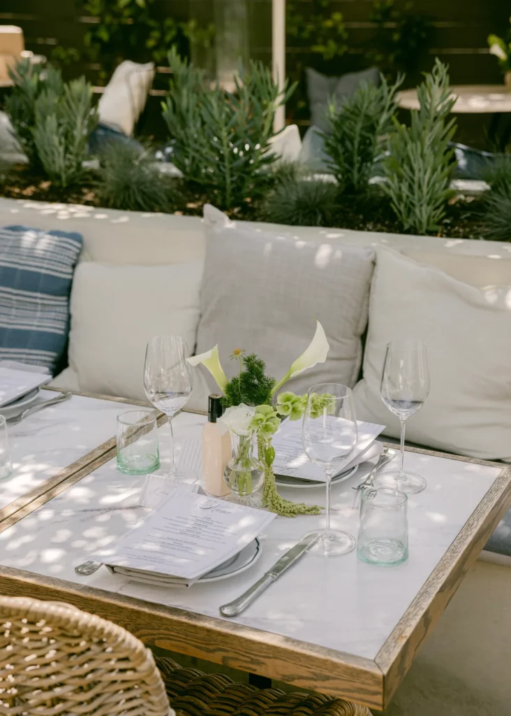 Outdoor celebration table with flowers and glassware
